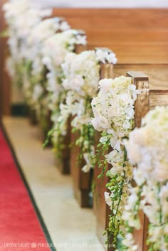 white flowers line the pews of a church