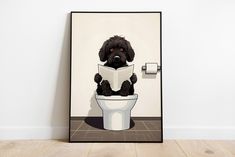 a black dog sitting on top of a toilet reading a book