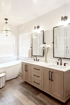 a large bathroom with two sinks and a tub