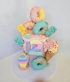 there is a cake that has donuts and other things on it in the shape of an eiffel tower