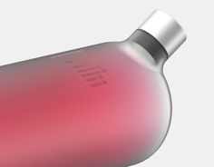 an image of a red and silver bottle on a white background that looks like it is in motion