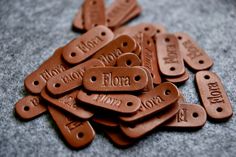 lots of leather tags with words on them