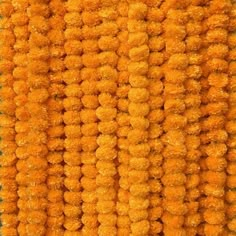 an orange carpet with lots of pom poms on the top and bottom of it