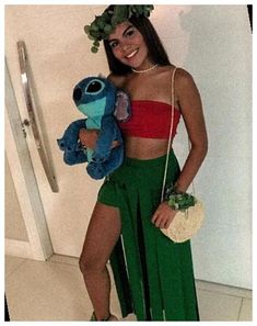 a woman in a green skirt holding a stuffed animal