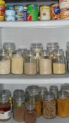 an open refrigerator filled with lots of different types of food in glass jars and containers