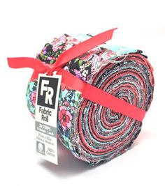 fabric roll with red ribbon on white background