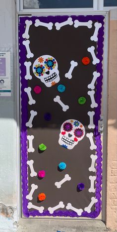 a door decorated with skulls and flowers on the front porch for day of the dead