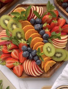 an image of fruit platter with apples, kiwis and blueberries on it