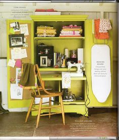 a green cabinet filled with lots of clutter and crafting supplies next to a wooden chair