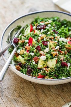 a white bowl filled with salad on top of a wooden table