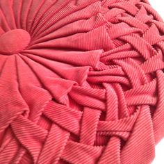 a close up view of a red object with many folds on the top and bottom