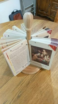 a bunch of books sitting on top of a table next to a wooden mallet