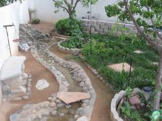 an outdoor garden with rocks and trees