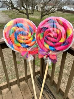 two lollipops sitting on top of wooden sticks