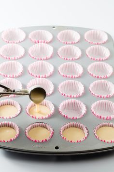 a muffin tin with cupcake batter being poured into it and ready to be baked