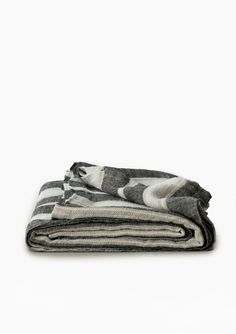 two folded blankets sitting on top of each other