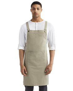 a man wearing an apron and standing in front of a white background with his hands on his hips