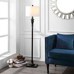 a living room with a blue couch and lamp