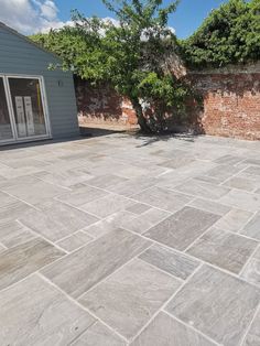 an empty patio with brick walls and trees