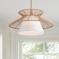 a light fixture hanging from the ceiling in a room with white walls and flooring