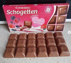 a box of schogeten chocolate with cream's berries on the side