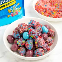 two bowls filled with cereal and sprinkles next to a bag of candy