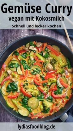 a pan filled with vegetables on top of a wooden table