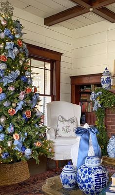 a living room decorated for christmas with blue and white decorations