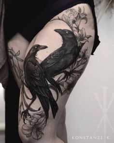 a woman's thigh with a black bird on it