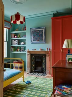 a bedroom with blue walls, green and red furniture and a colorful rug on the floor