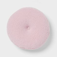 a pink round cushion on a white background