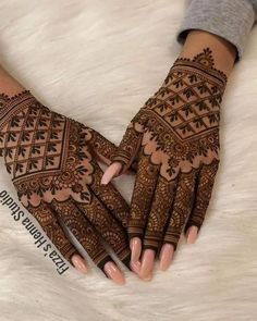 the hands are decorated with henna designs