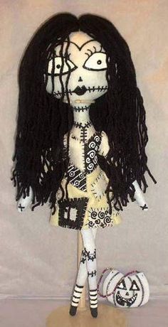 a doll with long black hair wearing a dress