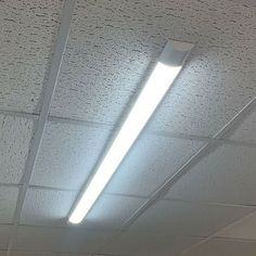 an office ceiling with fluorescent lighting and white paint