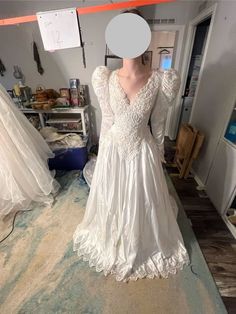 1990's vintage long sleeved wedding dress with beautiful scalloped edging and puffer sleeves. The Train is beautiful and intricate with pretty cut outs and a lace trim. There is a big bow that is a perfect place to bustle the dress up.  asking $300 or best offer.  bust 36 waist 30 front length 66 back length 110" My Mother in law bought out a bridal store with the intention of having a lending shop for brides that could not afford dresses. Each dress is either new or a demo...there are a few that were used mixed in.  I am in SW Washington state and happy to have people come buy to try these on. also happy to send you measurements. However the model wears an off the shelf 8 in "Normal" clothing and zips right into an off the shelf 10 in wedding gowns. if that helps. Buyer pays shipping Cottagecore Vintage Wedding Dress With Lace Trim, Vintage Long Sleeve Wedding Dress With Lace Patchwork, Retro Vintage Wedding Dress With Lace Trim, Long Sleeve Wedding Dress 80s, Long Sleeved Wedding Dress, White Vintage Long-sleeve Dress With Lace Trim, 90s Wedding Dress, Sleeved Wedding Dress, Wedding Dress With Long Sleeves