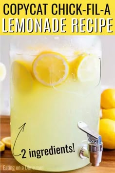 a pitcher filled with lemonade sitting on top of a wooden table next to sliced lemons