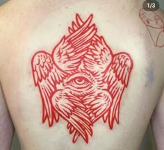 the back of a man with red ink on his body and an eye in the center