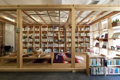 a room filled with lots of books and wooden shelves