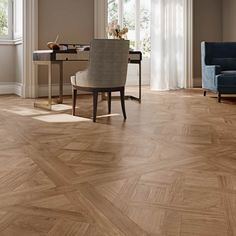 a living room filled with furniture and a wooden floor covered in hard wood planks