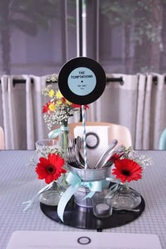 a table with flowers and silverware on it in front of a sign that says the testimos