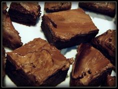 chocolate brownies with peanut butter frosting on a white plate