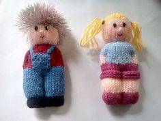 two knitted dolls sitting next to each other