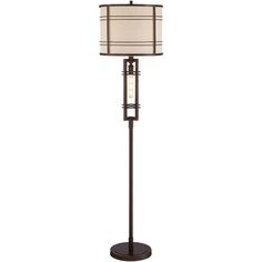 a floor lamp with a white shade on the top and a black base, in front of a white background