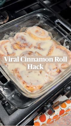 a pan filled with cinnamon rolls sitting on top of an oven