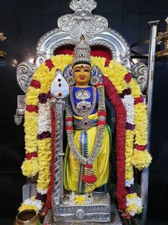 the statue is decorated with yellow and red flowers