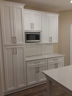 a kitchen with white cabinets and an oven