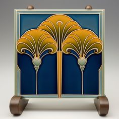 an art deco tile with three golden flowers on blue and gold background, designed in the style of art deco