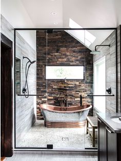 a bathroom with a large tub in the middle of it and a walk in shower