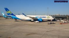 an airplane that is sitting on the tarmac at an airport with another plane in the background