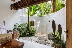 an outdoor shower in the middle of a tropical garden